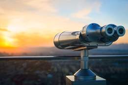 binoculars in observatory looking out on city